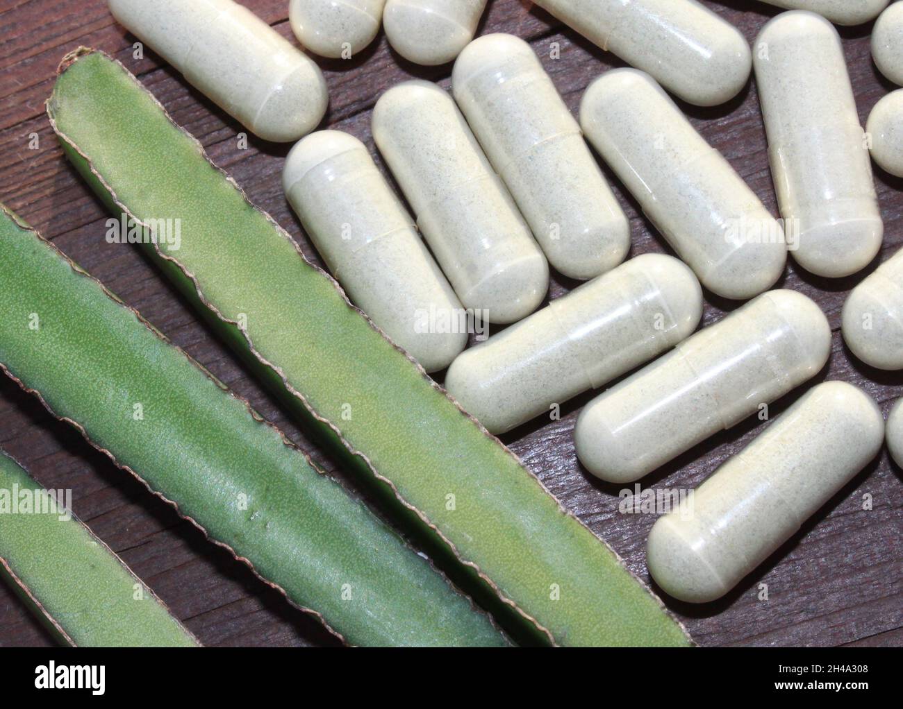 devil`  s backbone and capsules on a brown wooden board Stock Photo
